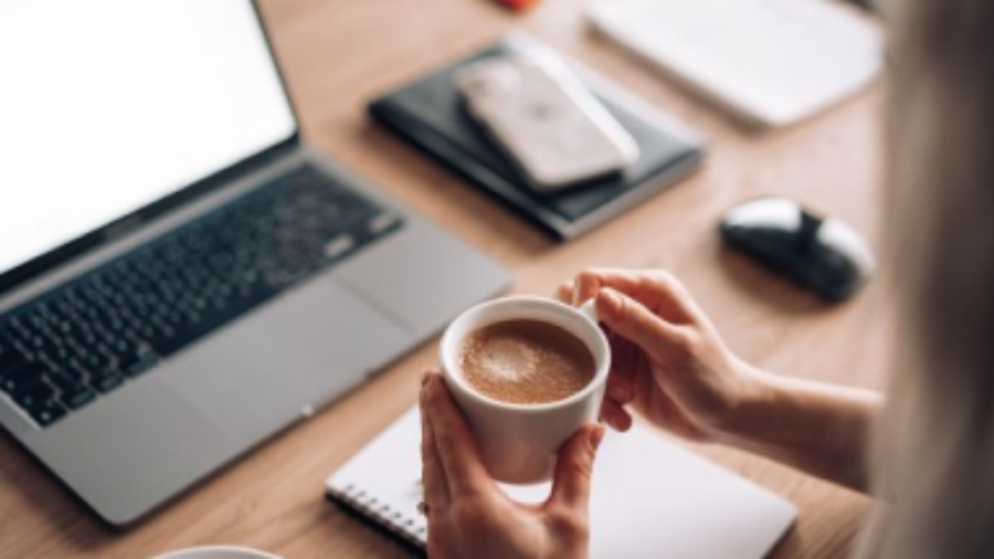 woman-holding-a-cup-of-coffee-at-work-home-office